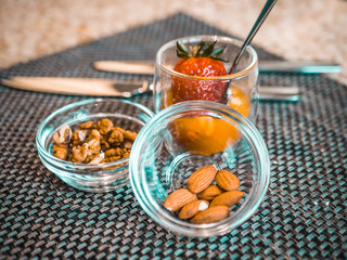 Nuts and strawberries in glass bowls. delicious snacks for breakfast in the hotel restaurant