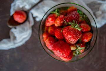 Red ripe strawberries in a glass Cup on a dark background