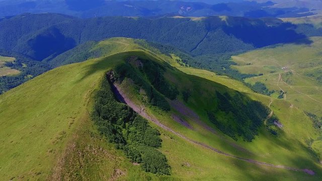 Aerial of a sharp peak with neo-expressionism cloud shades in the Carpathians