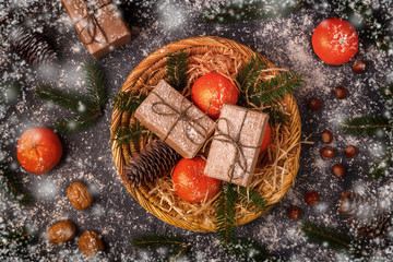 Christmas composition with tangerines, gift boxes, cones.