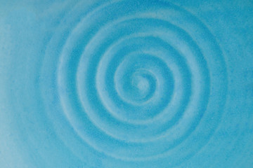 Fototapeta na wymiar Blue rippled water waves. Blue background. Ceramic dish
