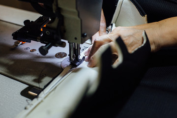Woman hands sewing leather piece