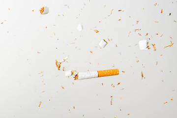 Broken cigarette flies in the air against a light background. Conception of combating smoking