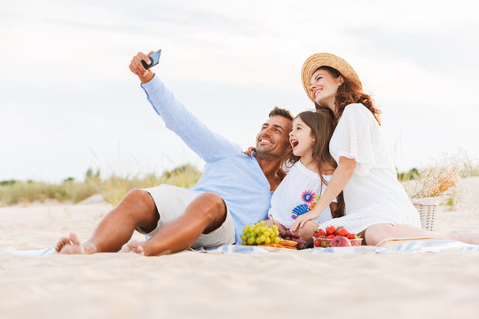 Happy family having fun together make selfie by mobile phone.