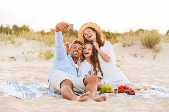 Happy family having fun together make selfie by mobile phone.
