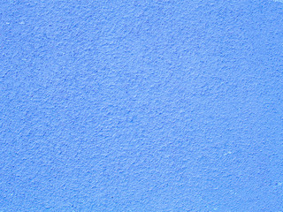 Blue wall background, empty. Old cracked paint pattern on wall. Peeling paint. Pattern of rustic blue grunge material. Wall covered with cracked paint. Flaking paint on a concrete wall. Copy space.