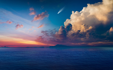 Bright comet in glowing sunset sky above dark blue sea - obrazy, fototapety, plakaty