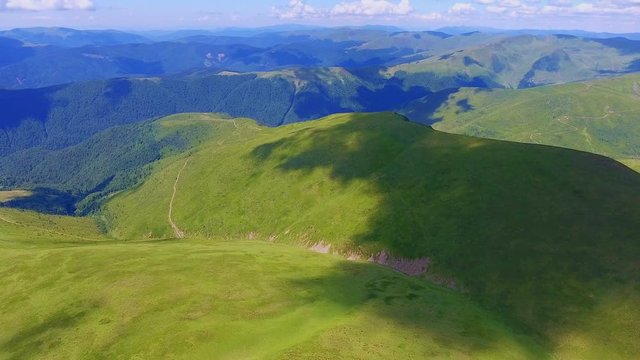 Aerial shot of long ranges with cloud shadesin the Carpathians in summer