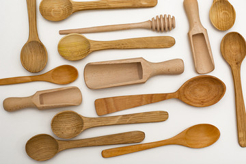 Set of wooden utensils, isolated on white background. View from above