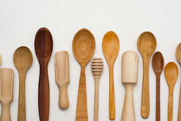 Set of wooden utensils, isolated on white background. View from above