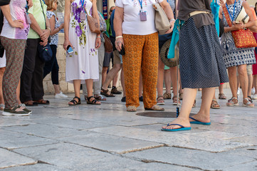 People standing in front of tourist guide