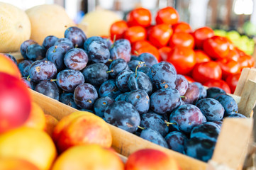 Plums and tomatoes on market