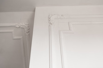 unfinished plaster molding on the ceiling and walls. decorative gypsum finish. plasterboard and...