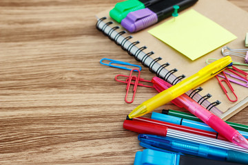 Fototapeta premium School supplies on a wooden table with space for text