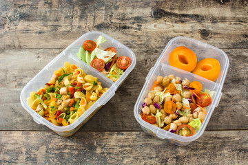 Lunch box with healthy food ready to eat on wooden table. Top view