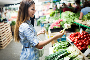 Picture of woman at marketplace buying vegetables
