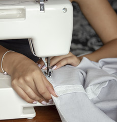 Designer woman sewing clothes
