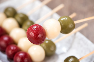 Japanese Dango dessert with 3 different color in pink(red), white, and green, recipe, hanami Dango, tsukimi Dango, copy space.
