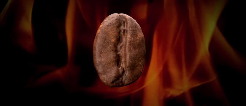 rotating close up coffee bean roasted by flames.