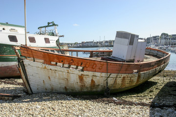 Fototapeta na wymiar 07-25-2018 Camaret France. Old boats in ship graveyard in Brittany France