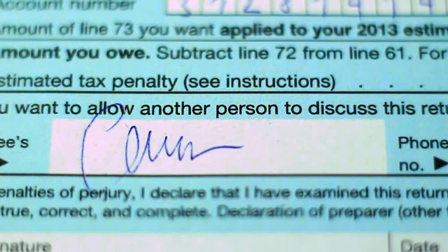 Tax document concept; 1040 document, signatures, numbers.