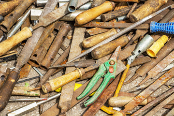 Disorderly scattered various hand work tools, files and rasps, hand tool texture background