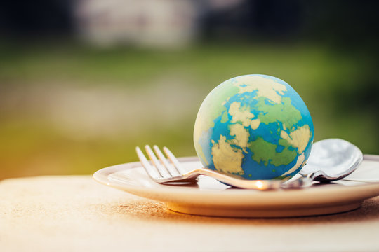 Globe model placed on plate with fork spoon for serve menu in famous hotels. International cuisine is practiced around the world. World food inter concept