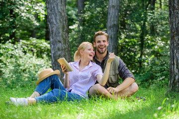 Fototapeta premium Couple in love spend leisure in park or forest. Romantic couple students enjoy leisure looking upwards observing nature background. Couple soulmates at romantic date. Romantic date at green meadow