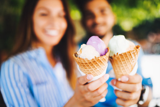 Happy couple having date and eating ice cream
