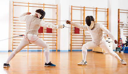 Fencers exercising techniques in battle