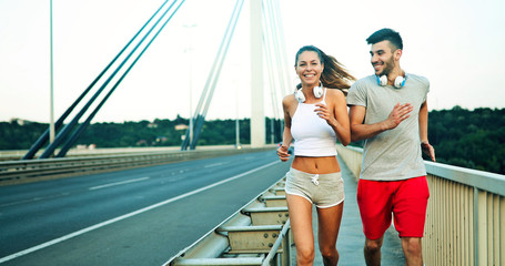 Attractive man and beautiful woman jogging together