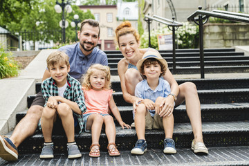 Happy familly of five in the park