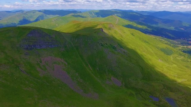 Aerial shot of a boundless range with gentle slopes in the Carpathians in summer