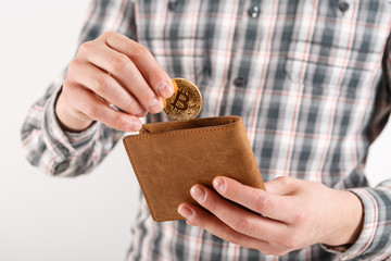 Obraz premium Businessman holding bitcoin. Golden bitcoin coin in men hands, pened wallet