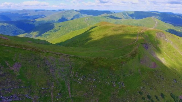 Aerial shot of a horizonless range with spiky peaks in the Carpathians in summer