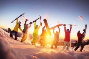 Crédence de cuisine en verre imprimé Sports dhiver Amis heureux à la station de ski s& 39 amusant au coucher du soleil