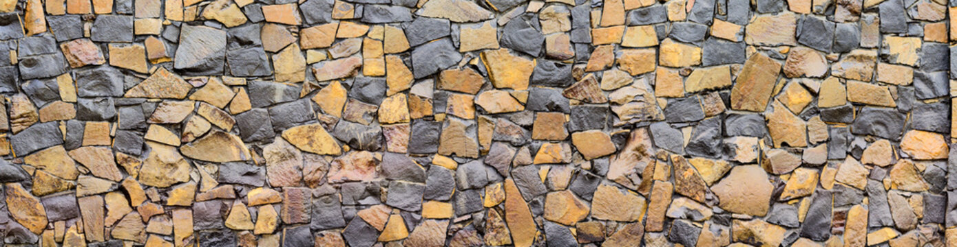 Dry old stone wall texture background close-up