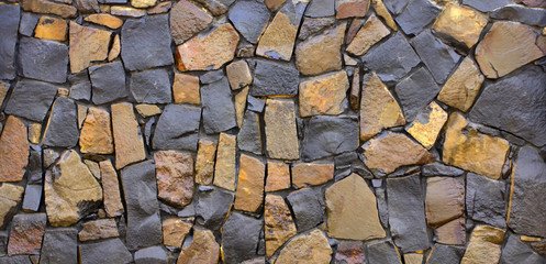 Dry old stone wall texture background close-up