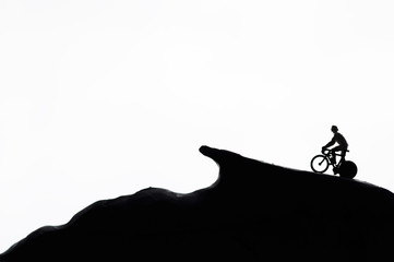 Obraz premium Silhouettes a man ride bicycle on the white background 