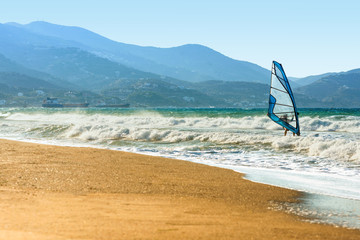 Windsurfers in the sea on Crete on sunset. Windsurfing in Heraklion