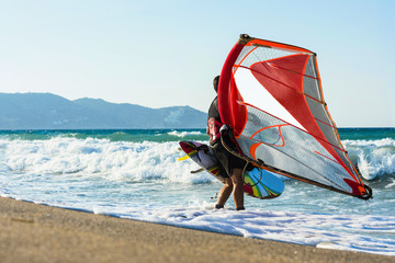 Windsurfer in the sea on Crete on sunset. Windsurfing in Heraklion © flowertiare
