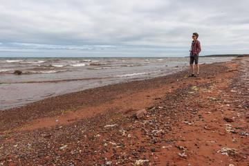 Tourist looking far away at the ocean beach in Prince Edward Island - 217146328