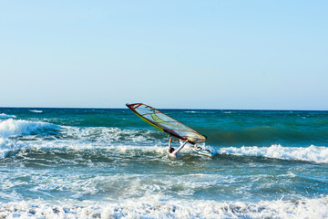 Windsurfers in the sea on Crete on sunset. Windsurfing in Heraklion