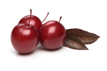 Red Cherry Plum with leaves, isolated on white background.