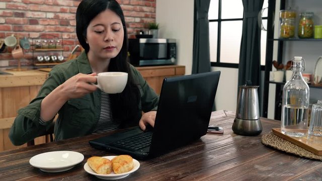 Woman having breakfast in the kitchen.