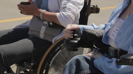 Impaired person using a joystick on a wheelchair. - Powered by Adobe