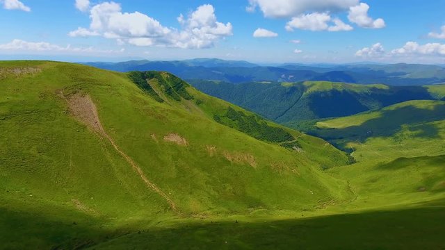Aerial of a long and thin gorge lying between mountains in the Carpathians in summer