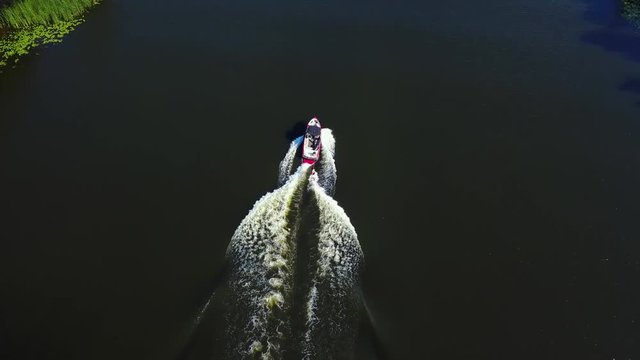 Motor boat pulls a wakeboarder