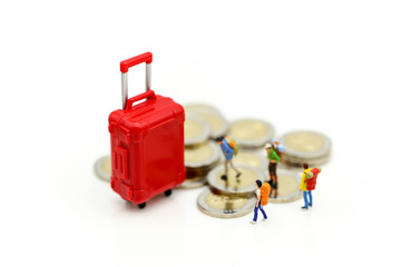 Miniature concept : Group of young traveler traveling / standing on coin Currency of the world,business trip traveler concept.
