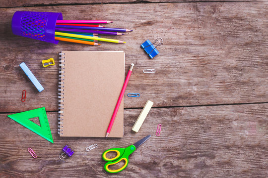 School supplies on a wooden background. Top view. School concept. Copy space
